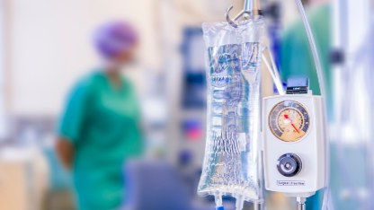 Hospital room scene with an IV drip and a nurse, highlighting materials used in medical devices such as rubber and ceramic